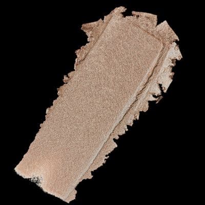 a close up of a piece of makeup on a black background