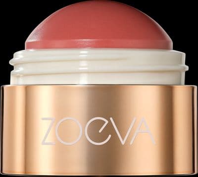 a close up of a pink lipstick on a black background