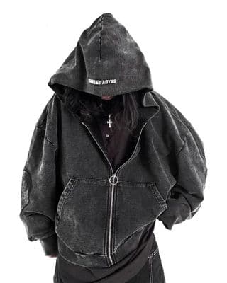 a person wearing a black hoodie with a cross on it