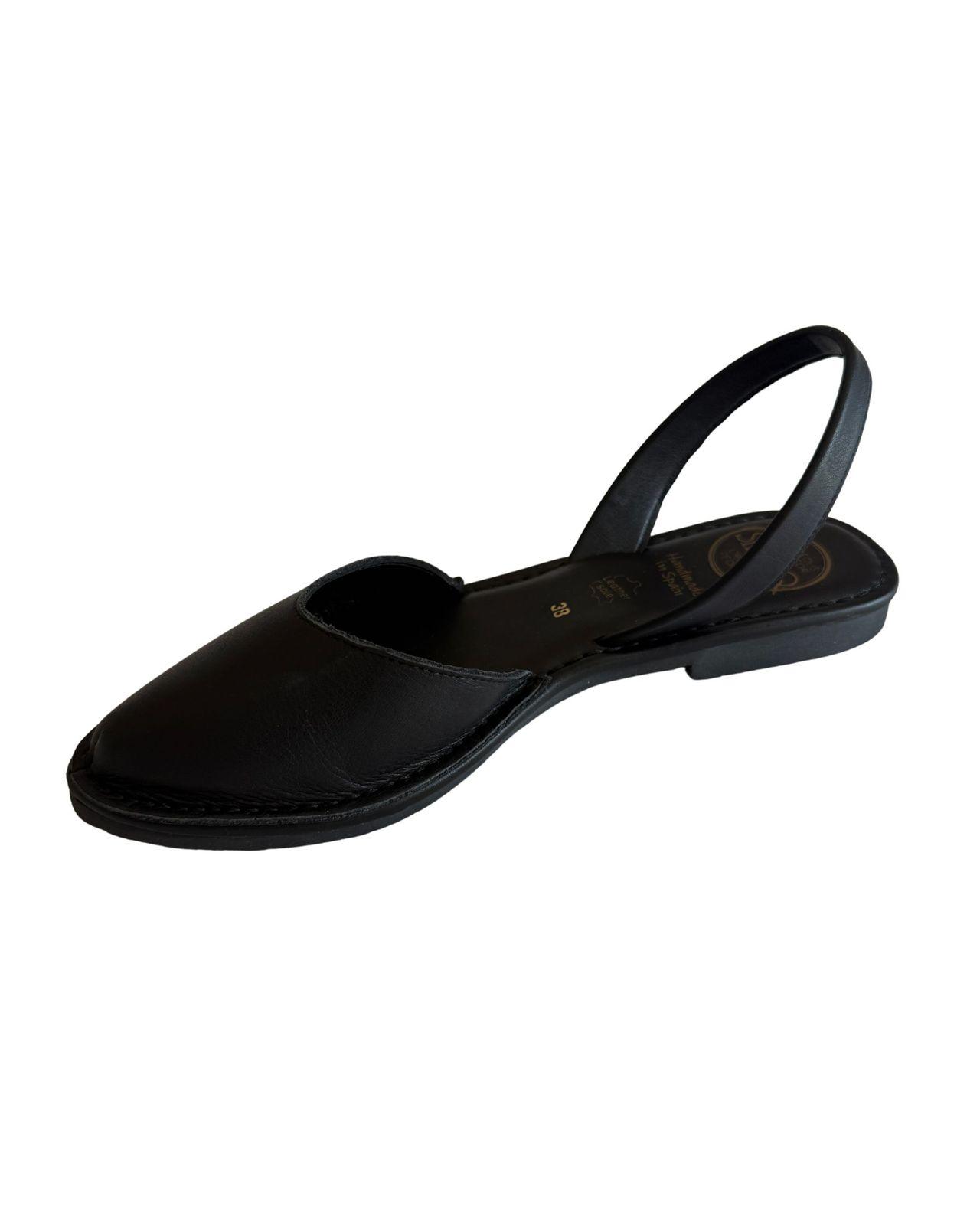 a woman's black shoe with a strap