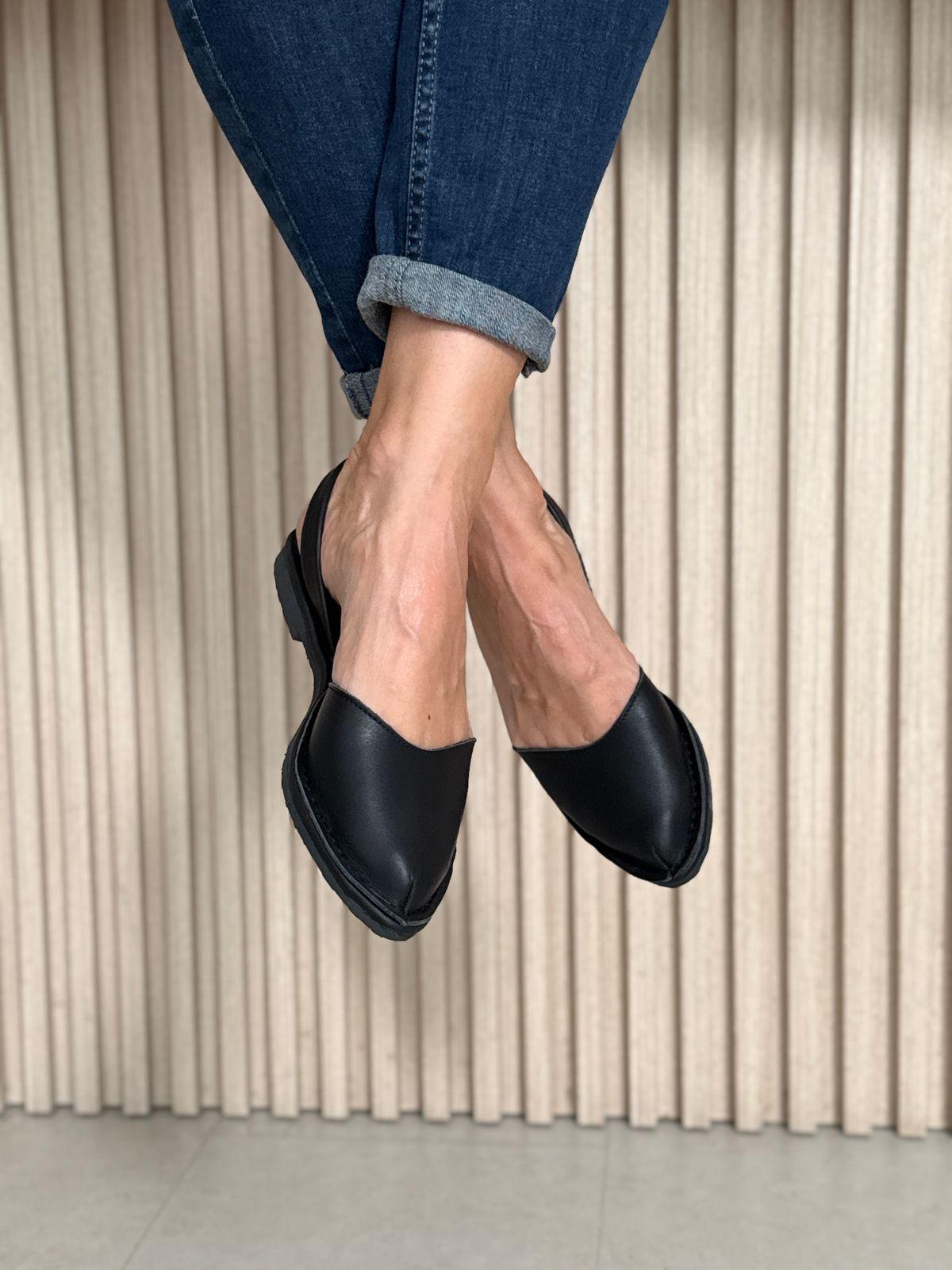 a close up of a person wearing black shoes