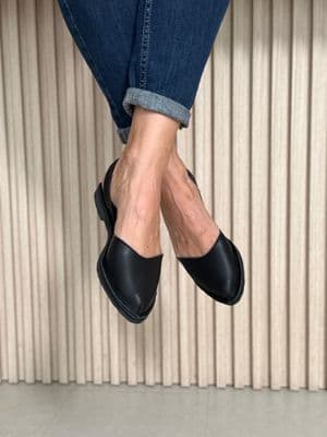a close up of a person wearing black shoes