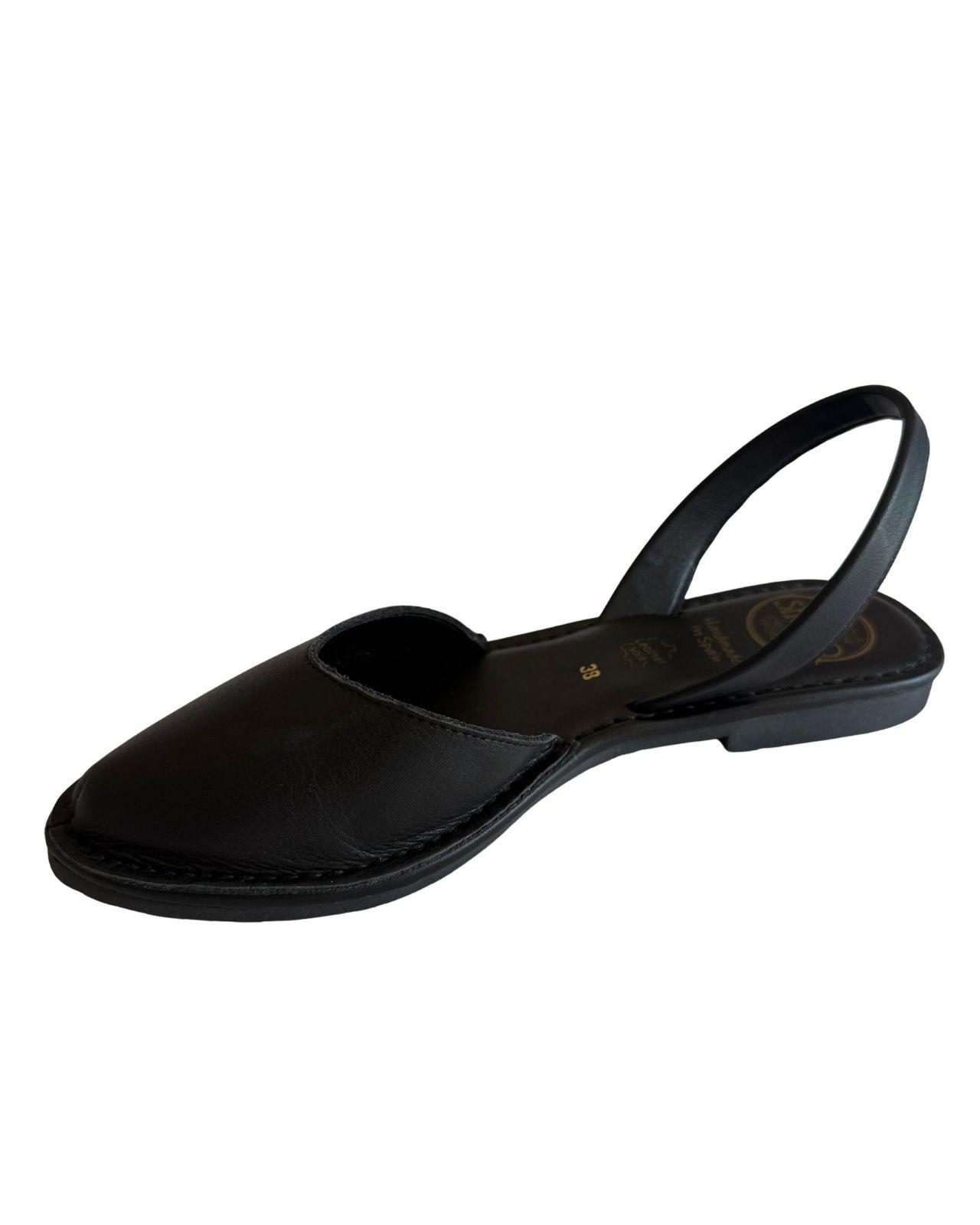 a woman's black shoe on a white background