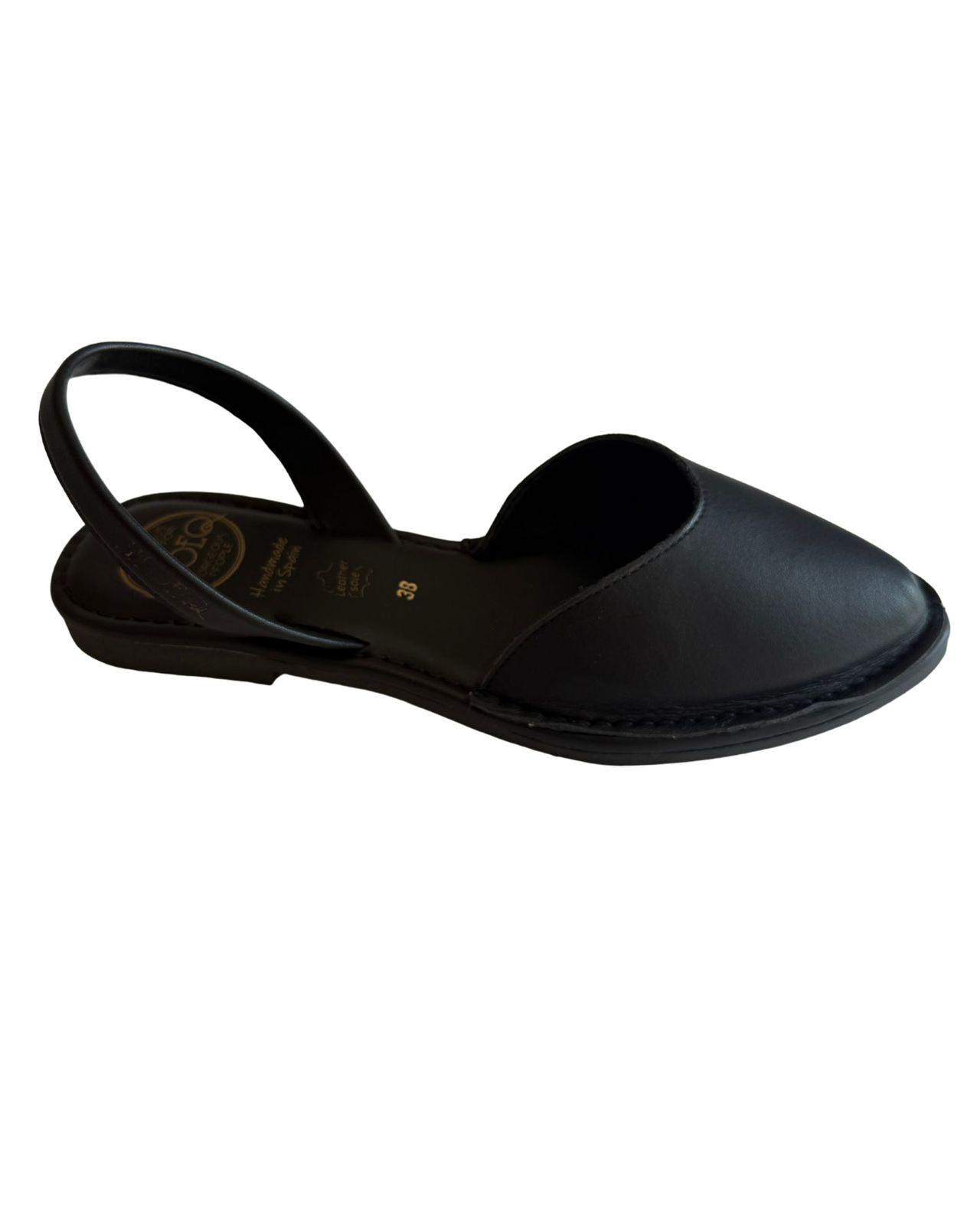 a woman's black shoe with a strap