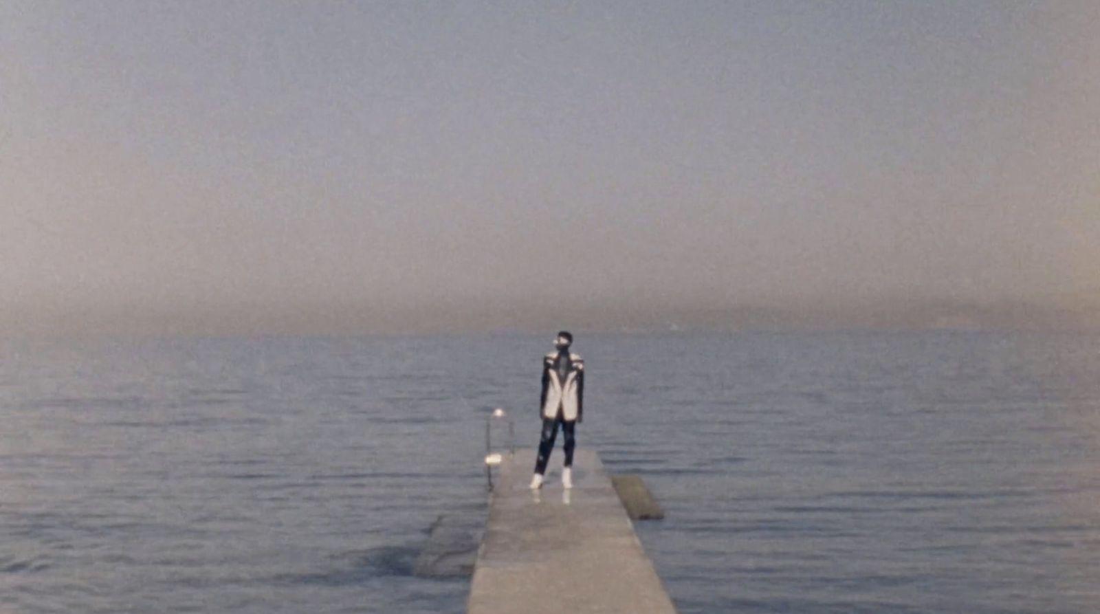 a person standing on a dock in the water