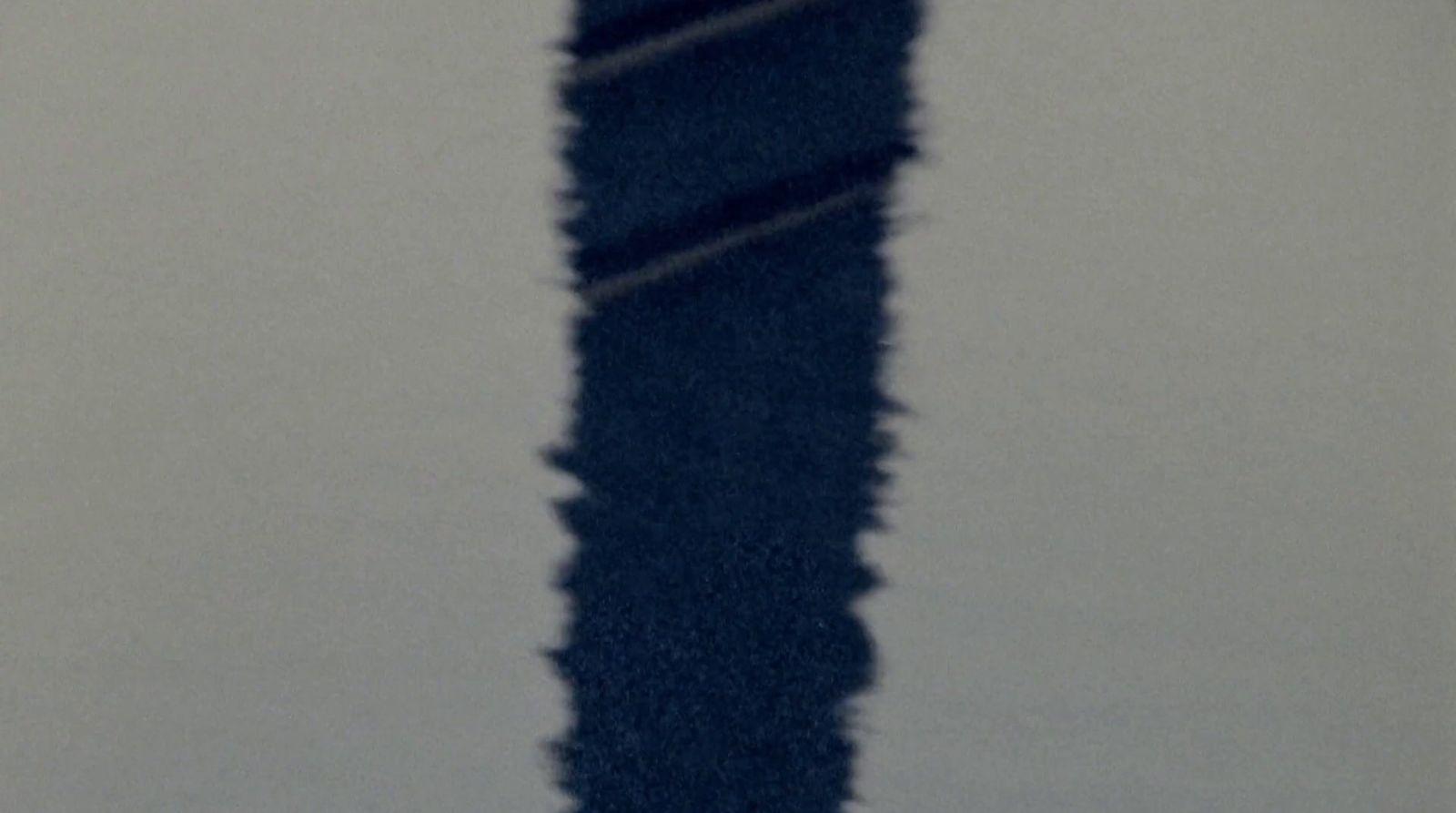 a long shadow of a person on a snowboard