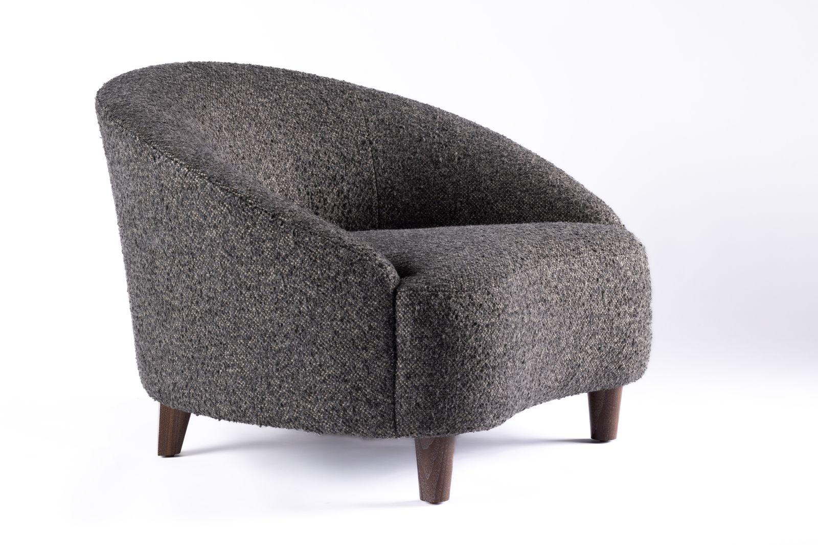 a gray chair with wooden legs and a white background