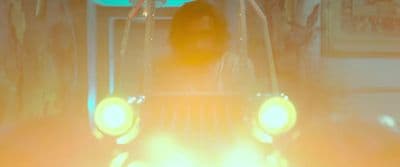 a person riding a vehicle with lights on