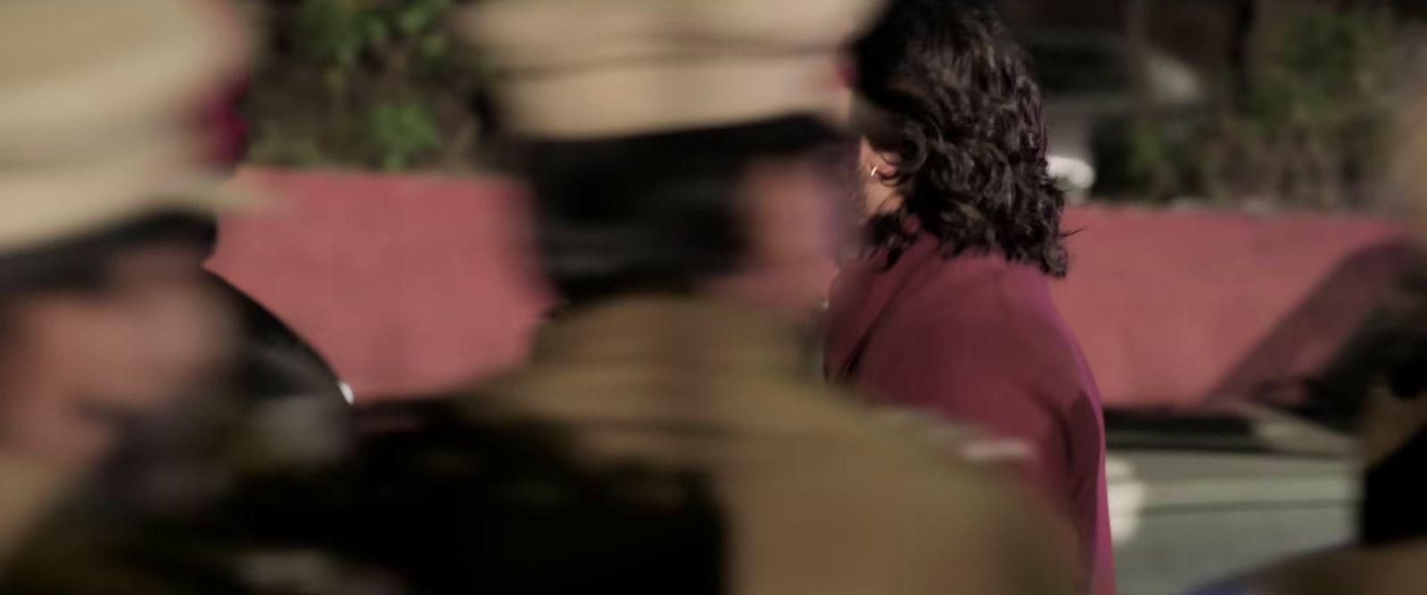 a blurry photo of a woman in a red coat