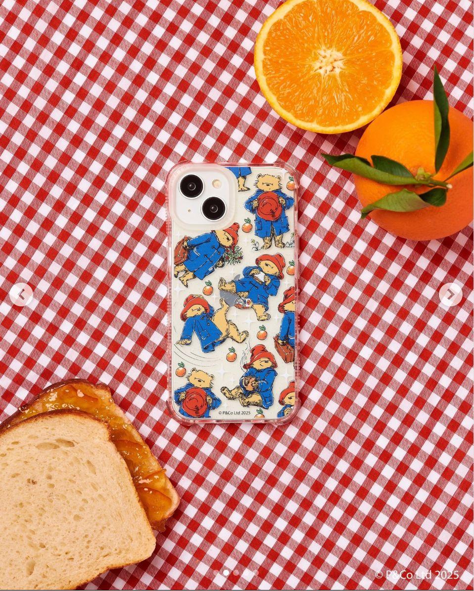 a sandwich and oranges on a red and white checkered table cloth