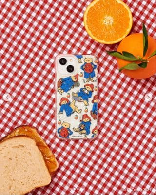 a sandwich and oranges on a red and white checkered table cloth