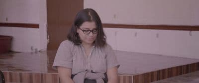 a woman sitting on a chair in a room