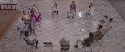 a group of people sitting in chairs in a room