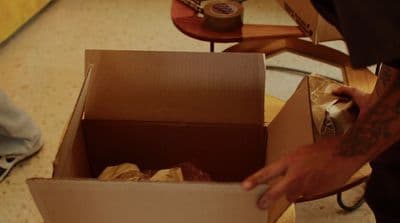 a man is opening a box with something in it
