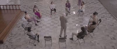 a group of people sitting in chairs in a room