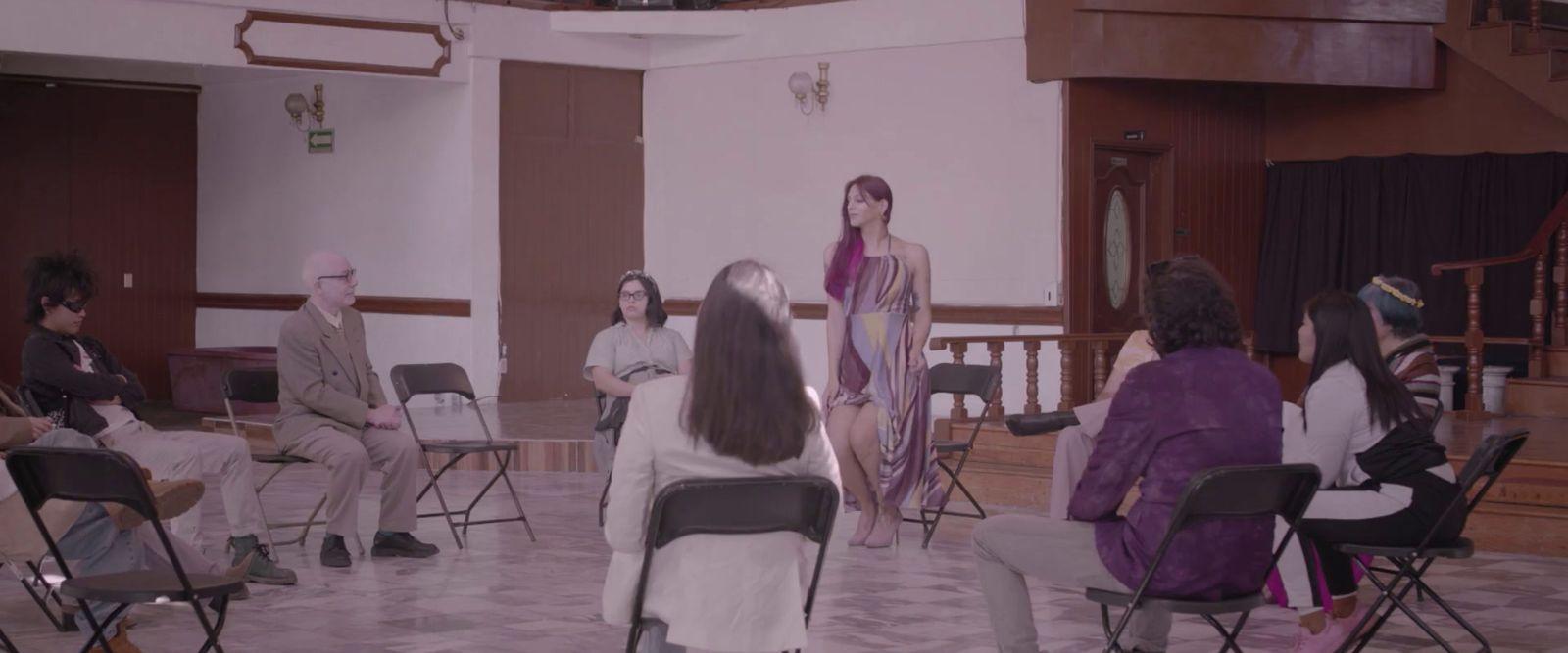 a group of people sitting in chairs in a room