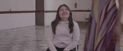 a woman sitting on a chair in a room