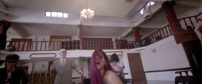 a group of people in a room with a chandelier
