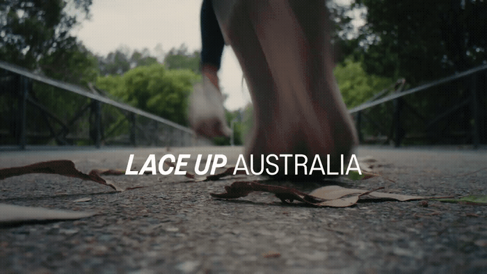 a close up of a person running on a path
