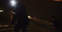 a person walking down a set of stairs at night