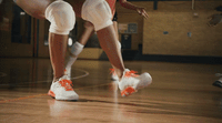 a close up of a basketball player's shoes on the court