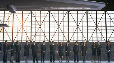 a group of people standing in front of a wall