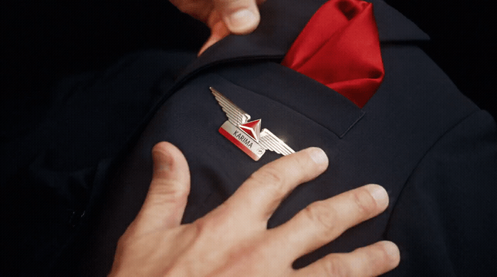 a close up of a person wearing a suit with a red tie