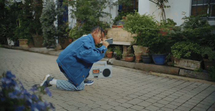 a man sitting on the ground taking a picture