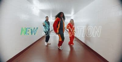 a group of people walking down a hallway
