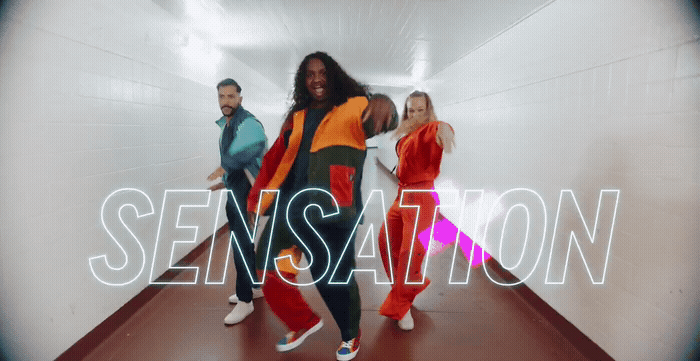 a group of people are dancing in a tunnel
