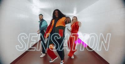a group of people are dancing in a tunnel