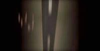 a shadow of a person standing in a room