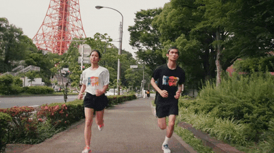 a couple of people that are running down a sidewalk