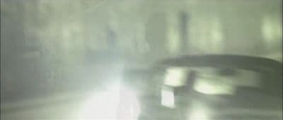 a blurry photo of a car driving down a street