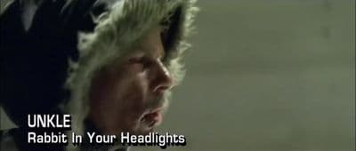 a man with a weird haircut has his mouth open