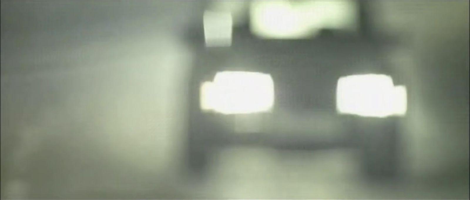 a blurry photo of a car driving down a road