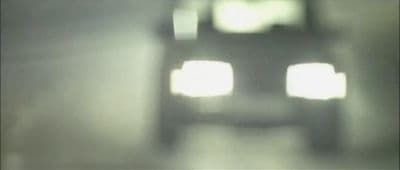 a blurry photo of a car driving down a road