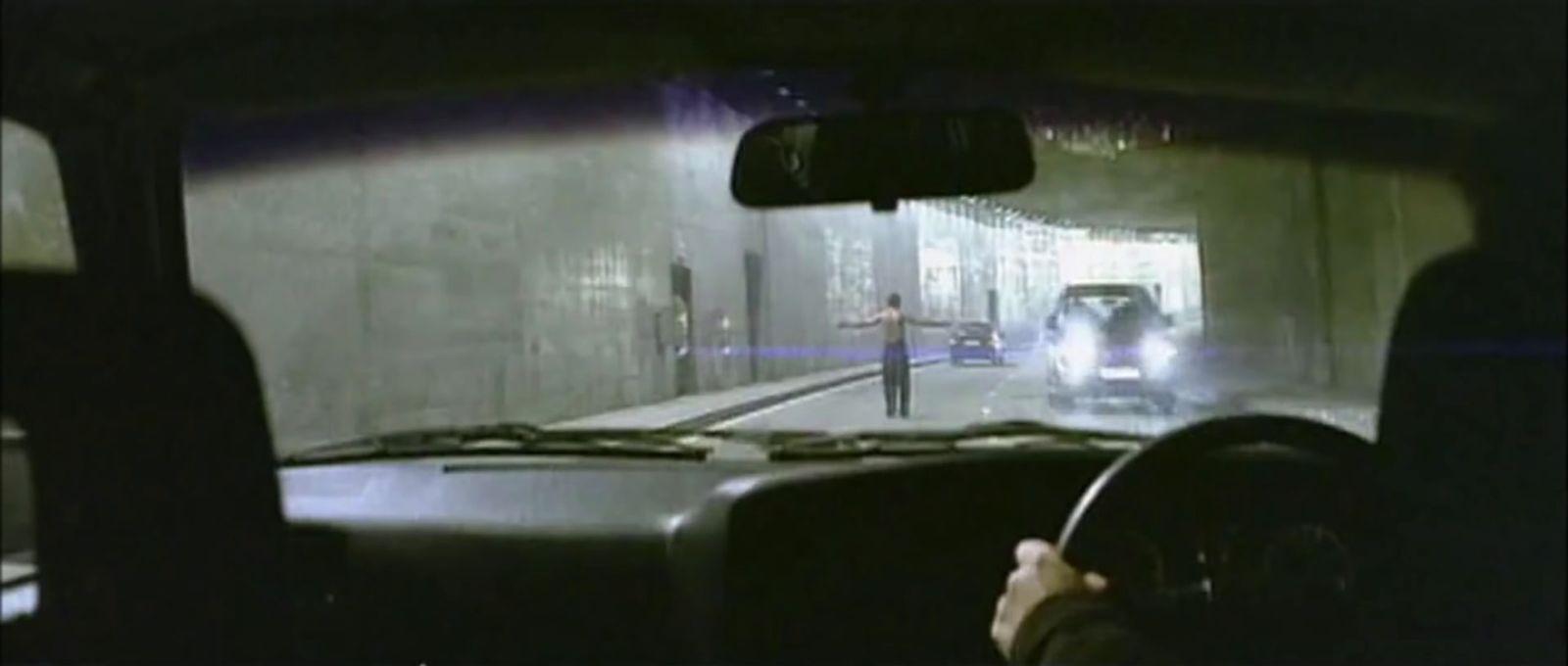 a man driving a car through a tunnel
