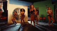 a group of women standing around each other