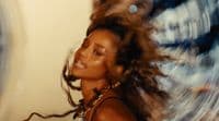 a woman with her hair blowing in the wind