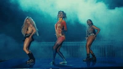 a group of women standing on top of a stage