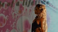 a woman standing in front of a wall with bubbles on it