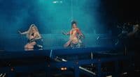 a couple of women that are standing on a stage