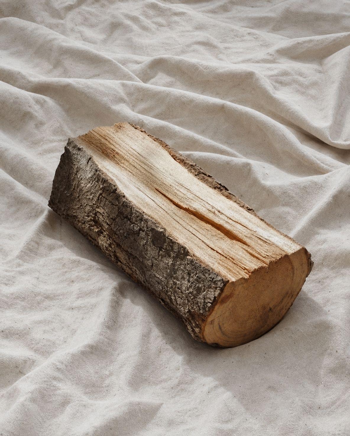 a piece of wood sitting on top of a white sheet