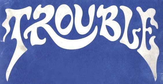 a blue background with white lettering that says trouble