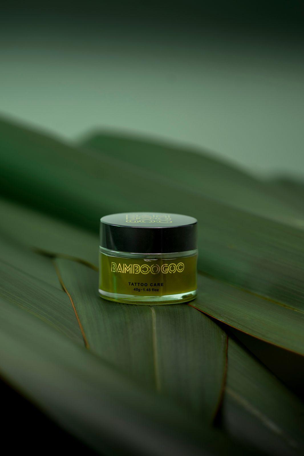 a jar of cream sitting on top of a leaf