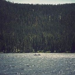 a person in a boat on a large body of water