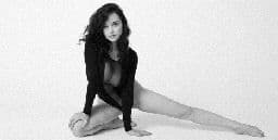 a black and white photo of a woman in a leotard