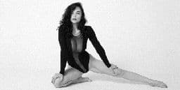 a woman sitting on the floor with her legs crossed