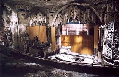 an abandoned theater with a wooden stage
